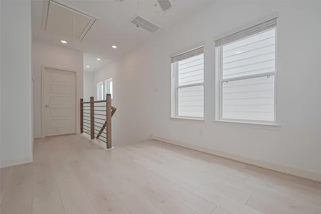 an empty room with windows and closet