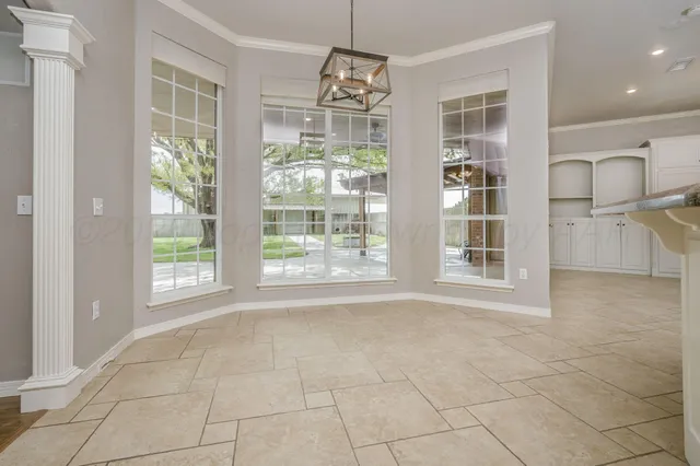 a kitchen with granite countertop white cabinets and a sink