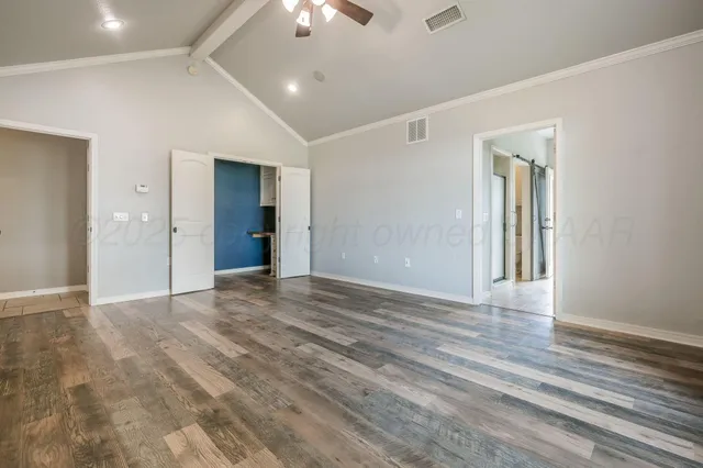 a spacious bathroom with a mirror a sink and a mirror