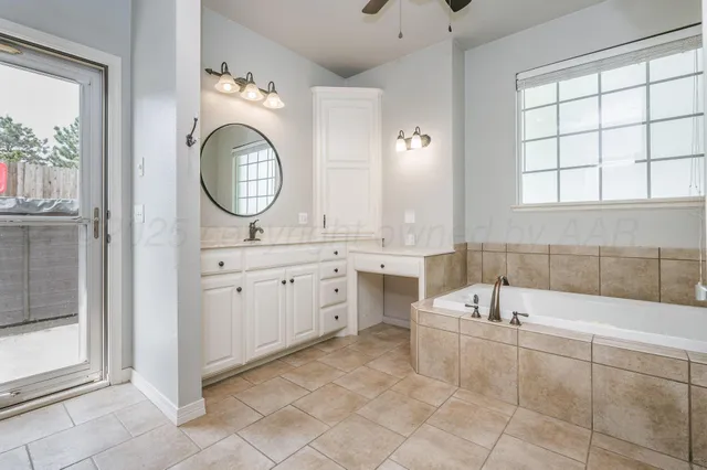 a bathroom with a tub sink and mirror
