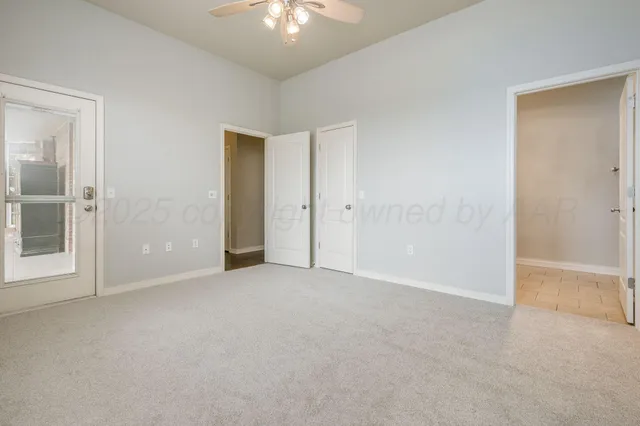 a view of a big room with wooden floor and windows