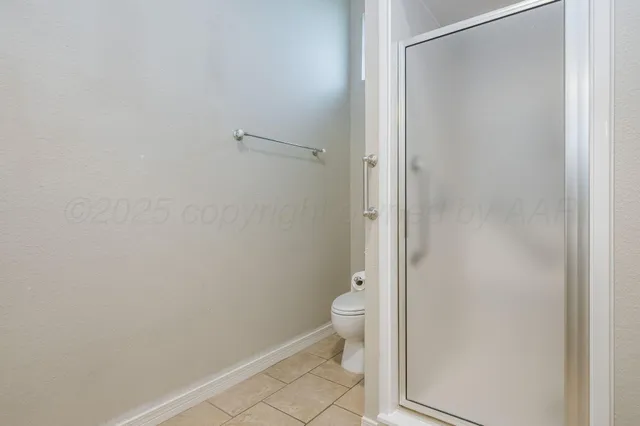 a view of a house next to a big yard and large trees