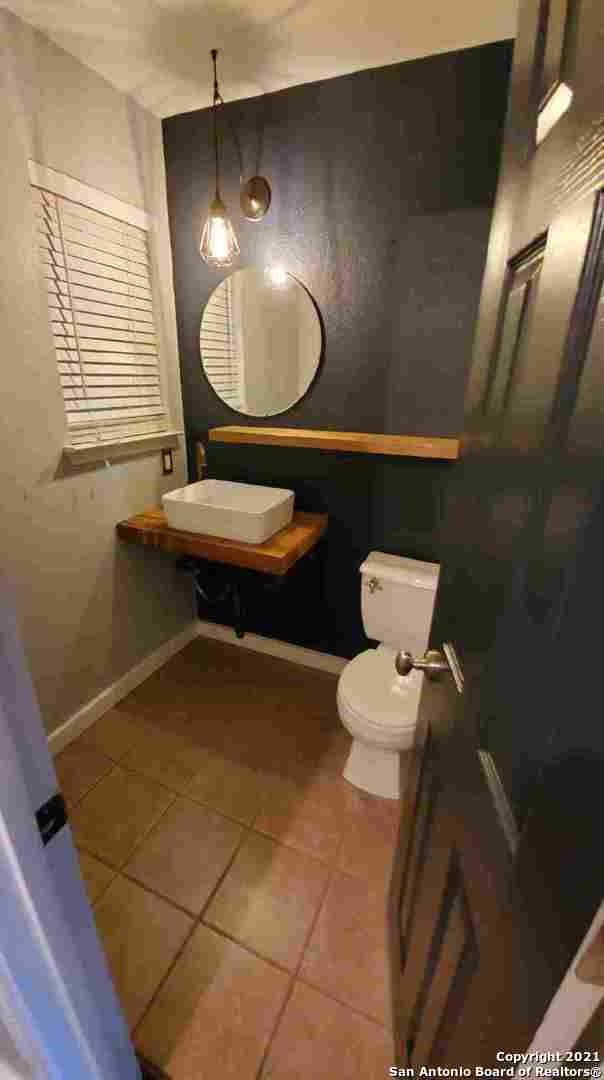 6307 Sentry Point San Antonio, TX 78233 - Photo 19 of 22 a bathroom with a toilet a sink and mirror