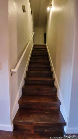 a view of a room with wooden floor