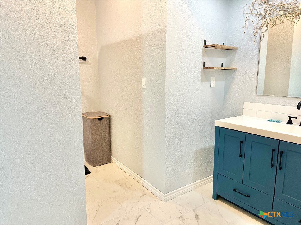 3109 Diane Street Port Bolivar, TX 77650 - Photo 15 of 17 a bathroom with a sink and a mirror