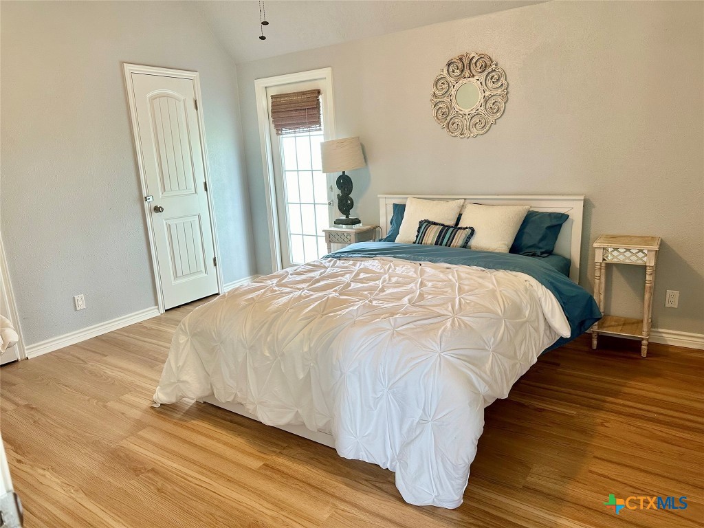 3109 Diane Street Port Bolivar, TX 77650 - Photo 3 of 17 a large bed sitting in a bedroom next to a window