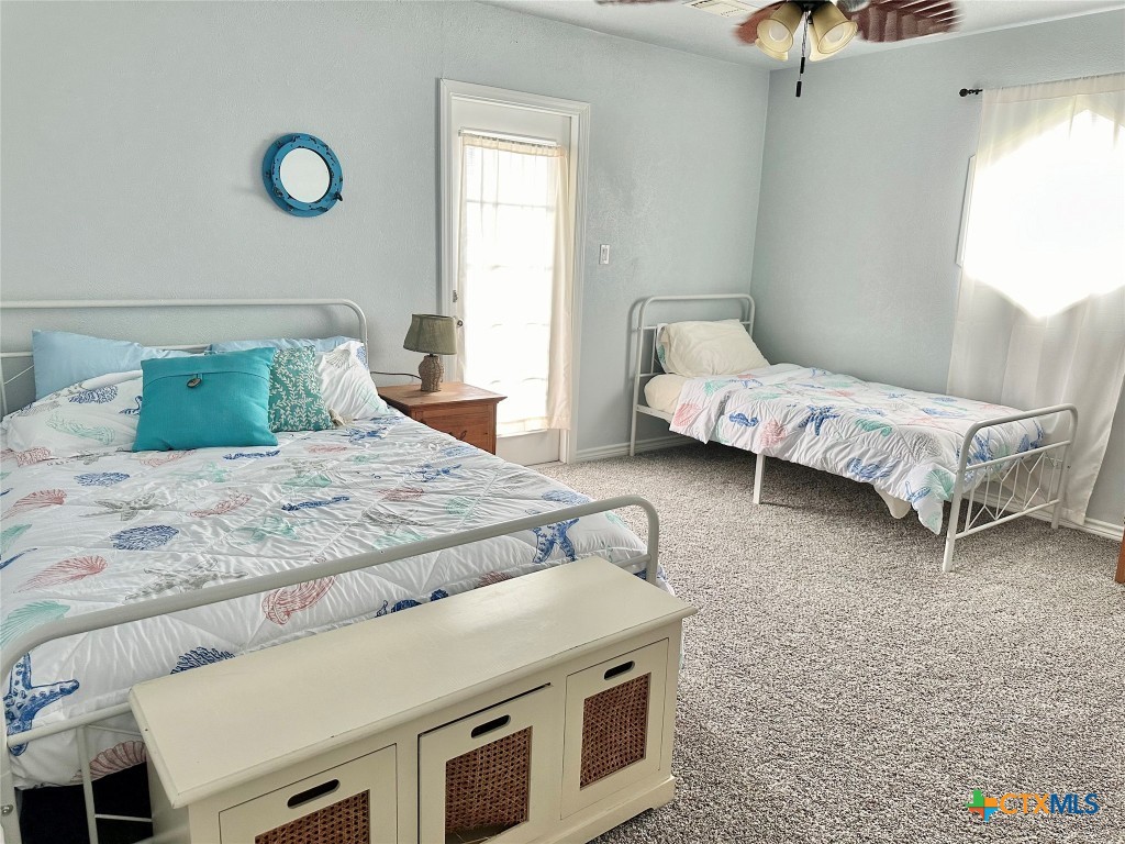 3109 Diane Street Port Bolivar, TX 77650 - Photo 10 of 17 a bedroom with a bed and a chandelier