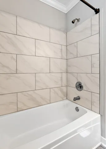 an empty room with wooden floor chandelier fan and windows