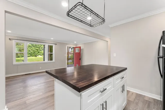 a bathroom with a granite countertop sink a mirror and a toilet