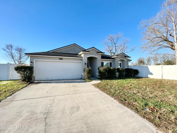 a front view of a house with a yard and garage