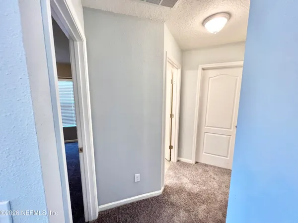 an empty room with a empty space and windows