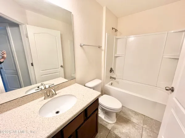 a view of kitchen and refrigerator