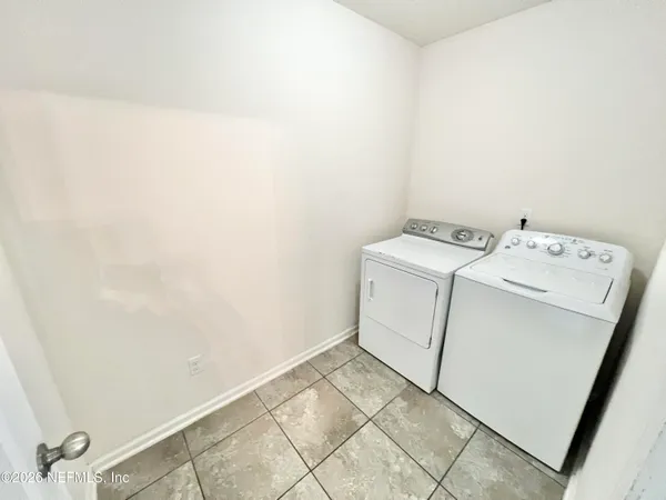 a view of a livingroom with a ceiling fan and window