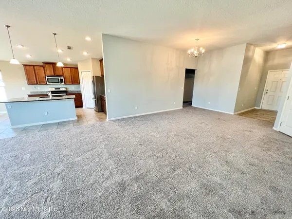 a view of a livingroom with a ceiling fan and window