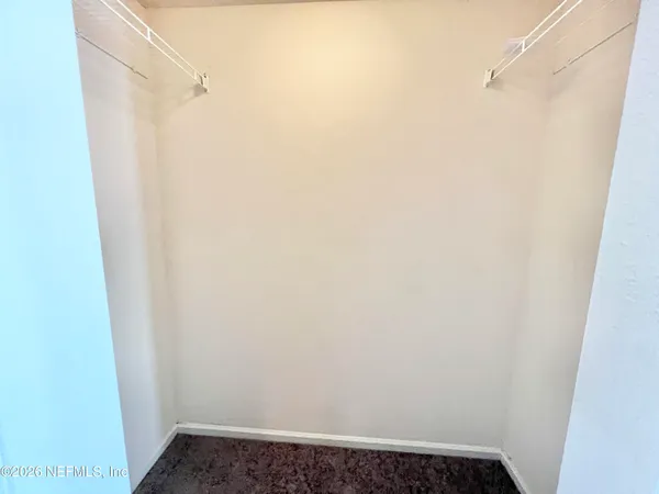 a bathroom with a granite countertop sink a mirror and a shower