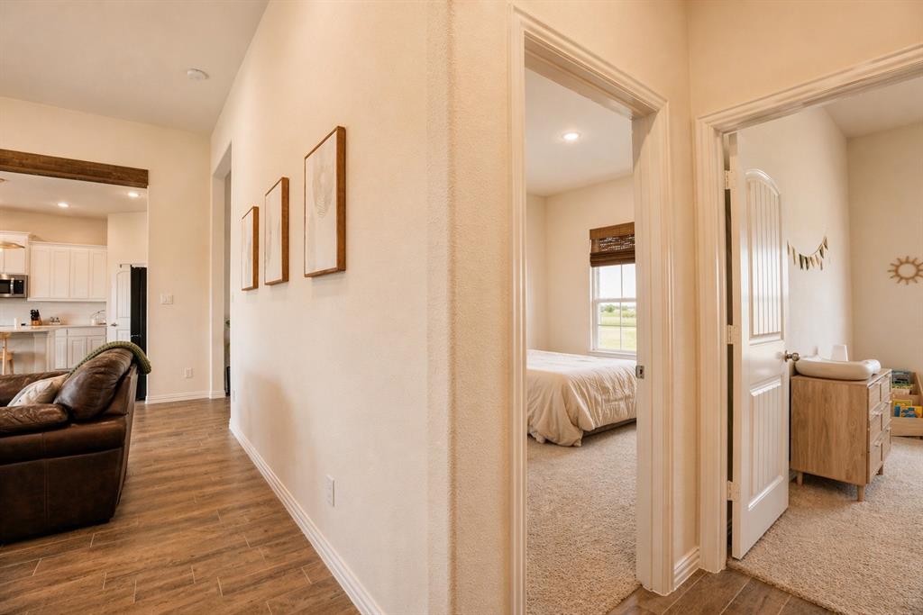 1530 County Road 200 Valley View, TX 76272 - Photo 26 of 34 Hallway with wood-finish tile flooring and neutral wall tones