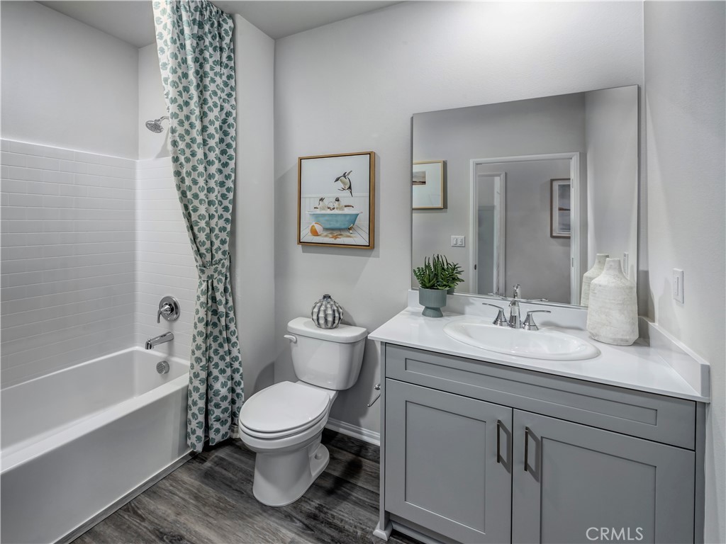 28285 Via Garnicia Temecula, CA 92591 - Photo 12 of 14 a bathroom with a granite countertop toilet a sink and a bathtub