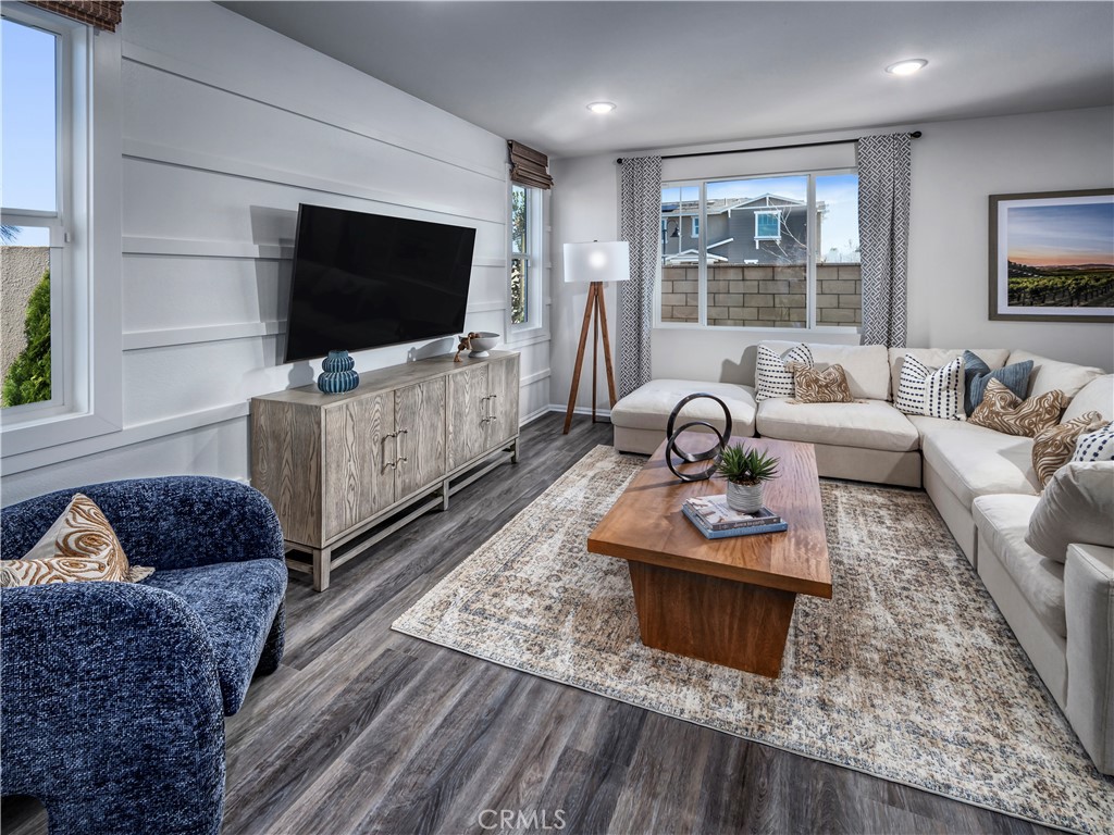 28285 Via Garnicia Temecula, CA 92591 - Photo 7 of 14 a living room with furniture a flat screen tv and a floor to ceiling window