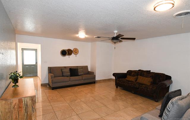 107903 South 4570 Road Sallisaw, OK 74955 - Photo 9 of 35 Neutral tone wall finishes, tiled flooring, recessed ceiling lighting, and a ceiling fan