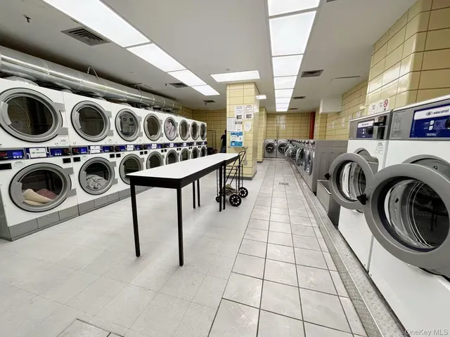 a utility room with dryer washer and other items