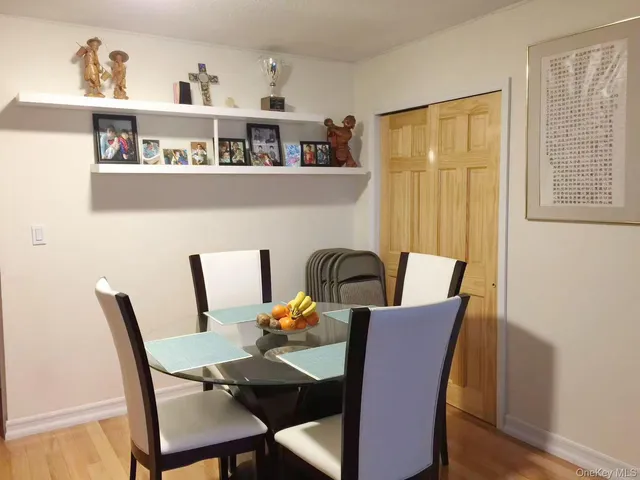 a view of a dining room with furniture a rug and wooden floor