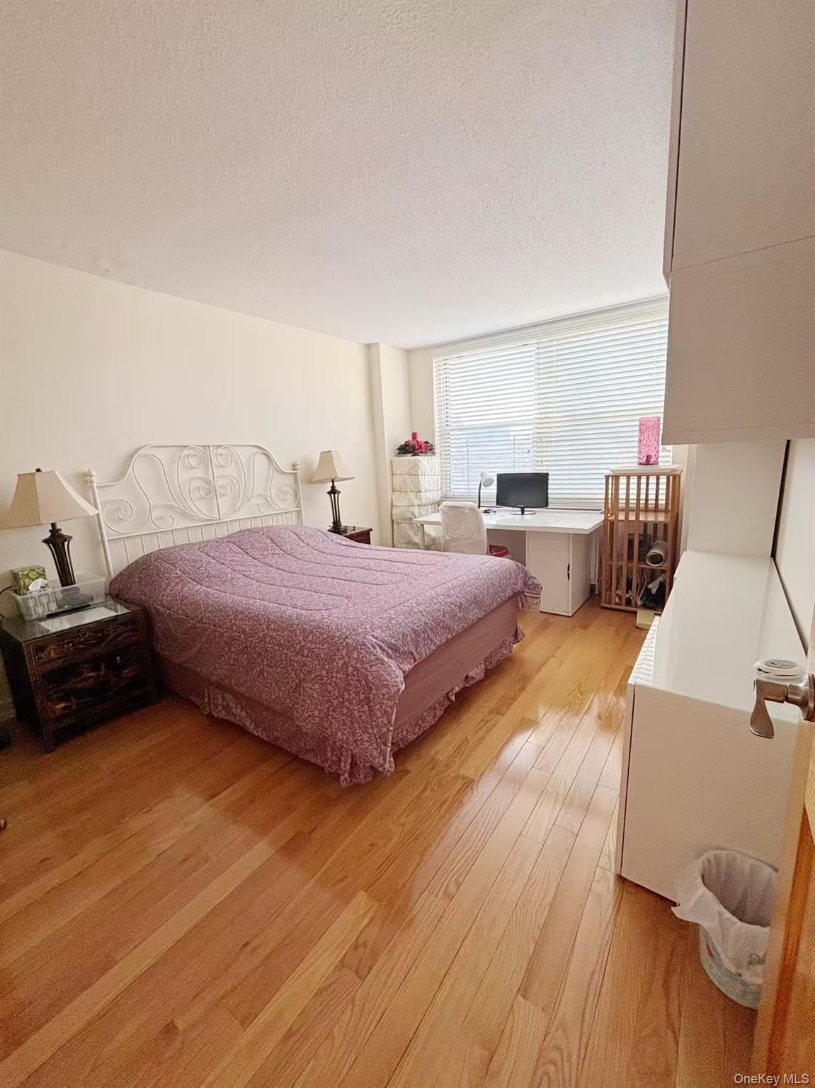 41-40 Union Street, Unit 6D Queens, NY 11355 - Photo 7 of 12 a bedroom with a bed and wooden floor