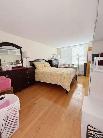 a bedroom with a bed and window