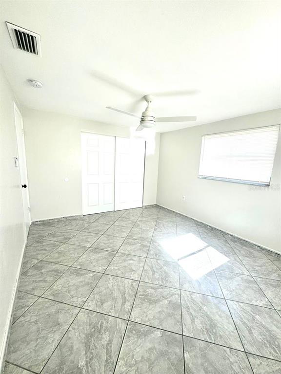 1019 Pert Lane Holiday, FL 34691 - Photo 6 of 12 an empty room with a empty space and windows