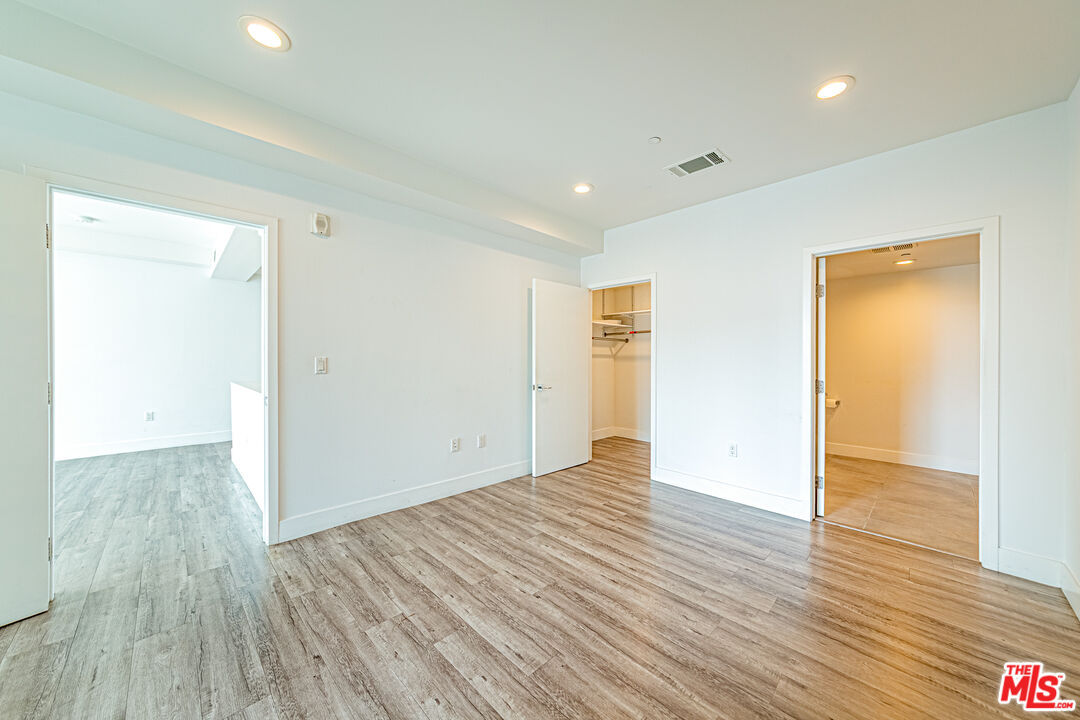 1101 South Harvard Boulevard, Unit 303 Los Angeles, CA 90006 - Photo 13 of 44 wooden floor in an empty room with a window