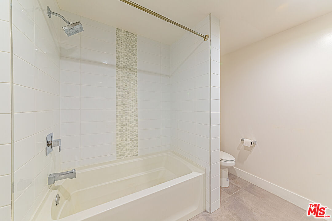 1101 South Harvard Boulevard, Unit 303 Los Angeles, CA 90006 - Photo 17 of 44 a bathroom with a bathtub and a shower