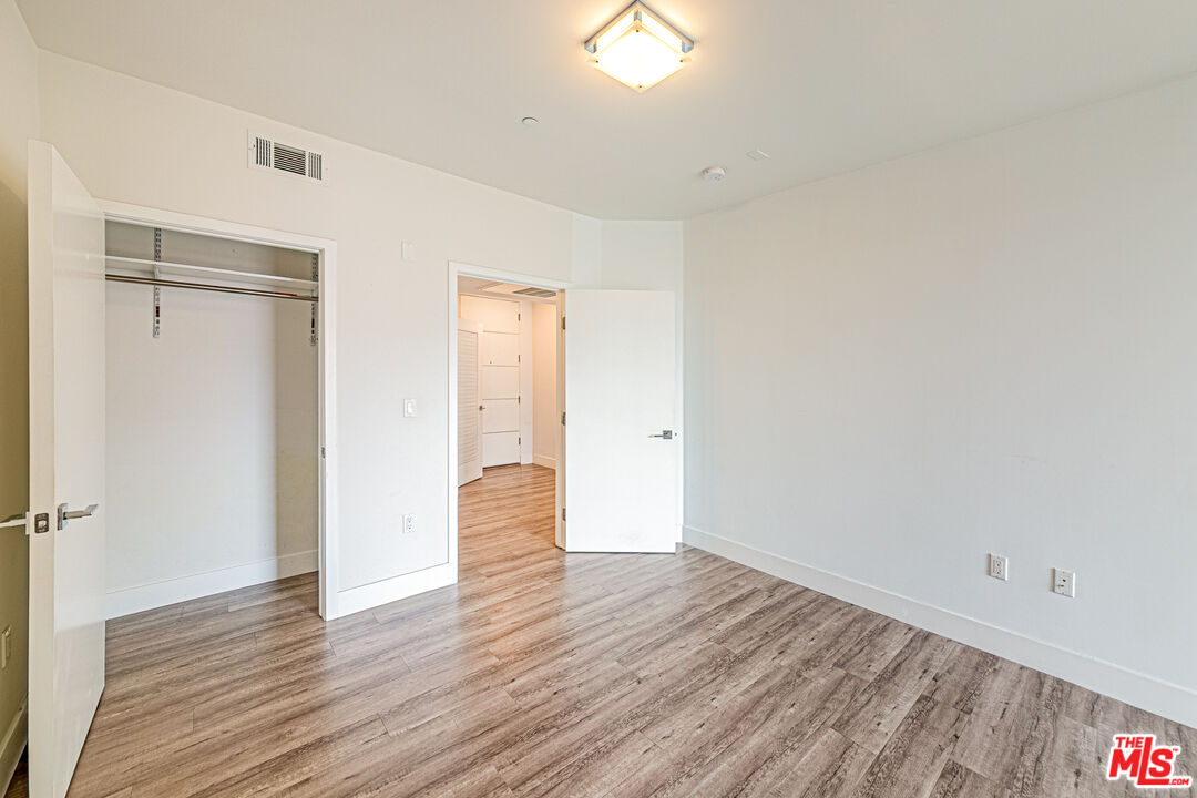 1101 South Harvard Boulevard, Unit 303 Los Angeles, CA 90006 - Photo 18 of 44 a view of an empty room with wooden floor