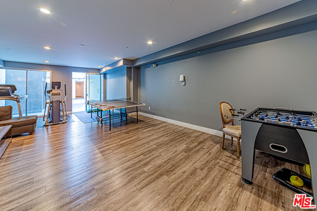 1101 South Harvard Boulevard, Unit 303 Los Angeles, CA 90006 - Photo 28 of 44 a view of a workspace with furniture and wooden floor