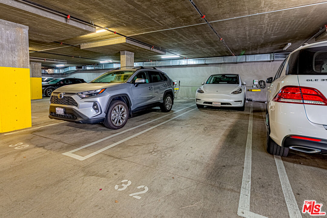 1101 South Harvard Boulevard, Unit 303 Los Angeles, CA 90006 - Photo 31 of 44 a view of parking garage with cars parked