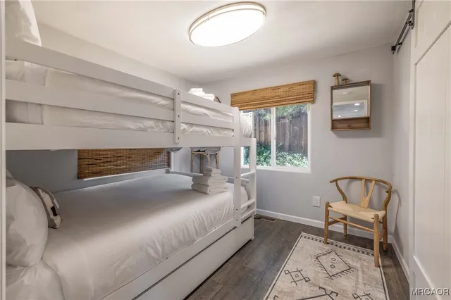 a bedroom with a bed and a mirror