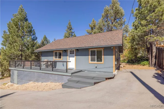 a view of deck with furniture and trees