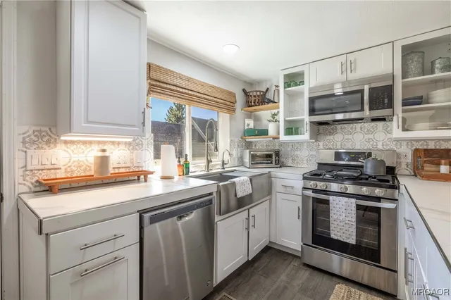 a kitchen with stainless steel appliances granite countertop a stove and a sink