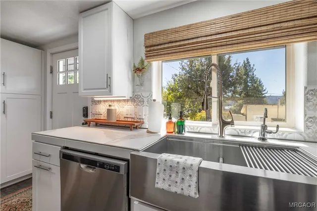 a kitchen with a sink cabinets and a large window
