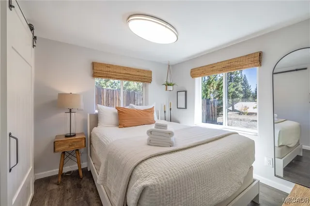 a bedroom with a bed and a large window