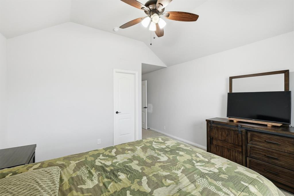 924 Timber Ridge Drive Justin, TX 76247 - Photo 26 of 32 Vaulted ceiling featuring a wood-finish ceiling fan with integrated lighting