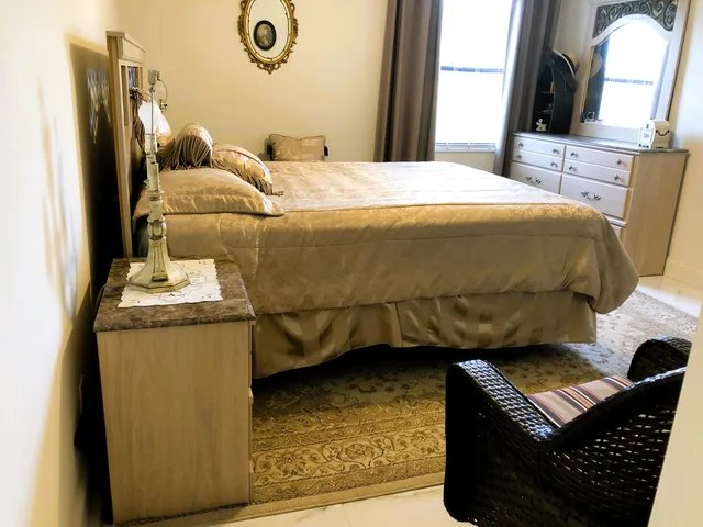 a bedroom with a bed and dresser