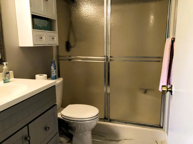 a bathroom with a toilet a sink and shower