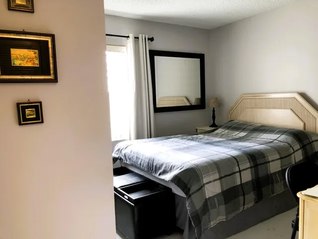 a bedroom with a bed and a mirror