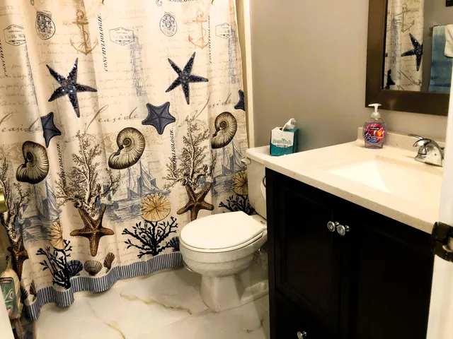 a bathroom with a sink toilet and shower