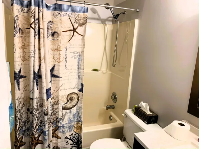 a bathroom with a toilet and shower