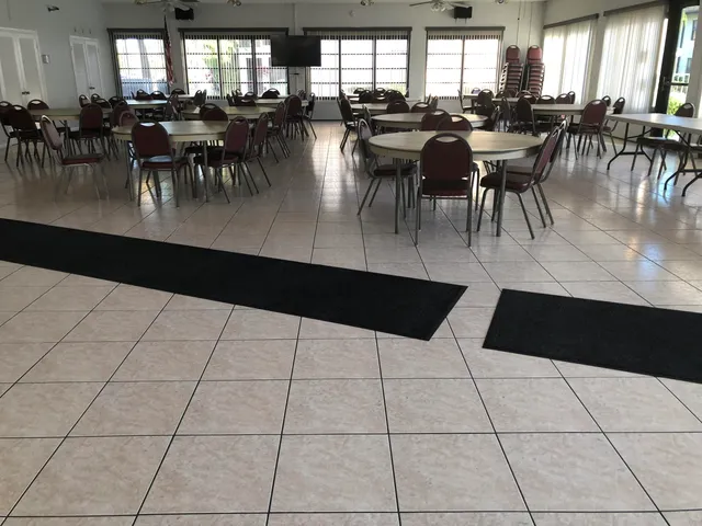 a dining hall with lots of tables a dining table and chairs