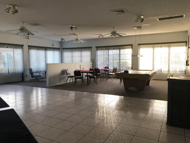a large hall with dining space and living room view
