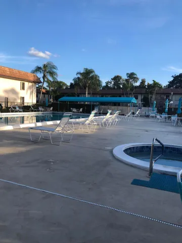 a view of a swimming pool with a yard