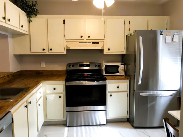 a kitchen with stainless steel appliances a refrigerator sink and cabinets