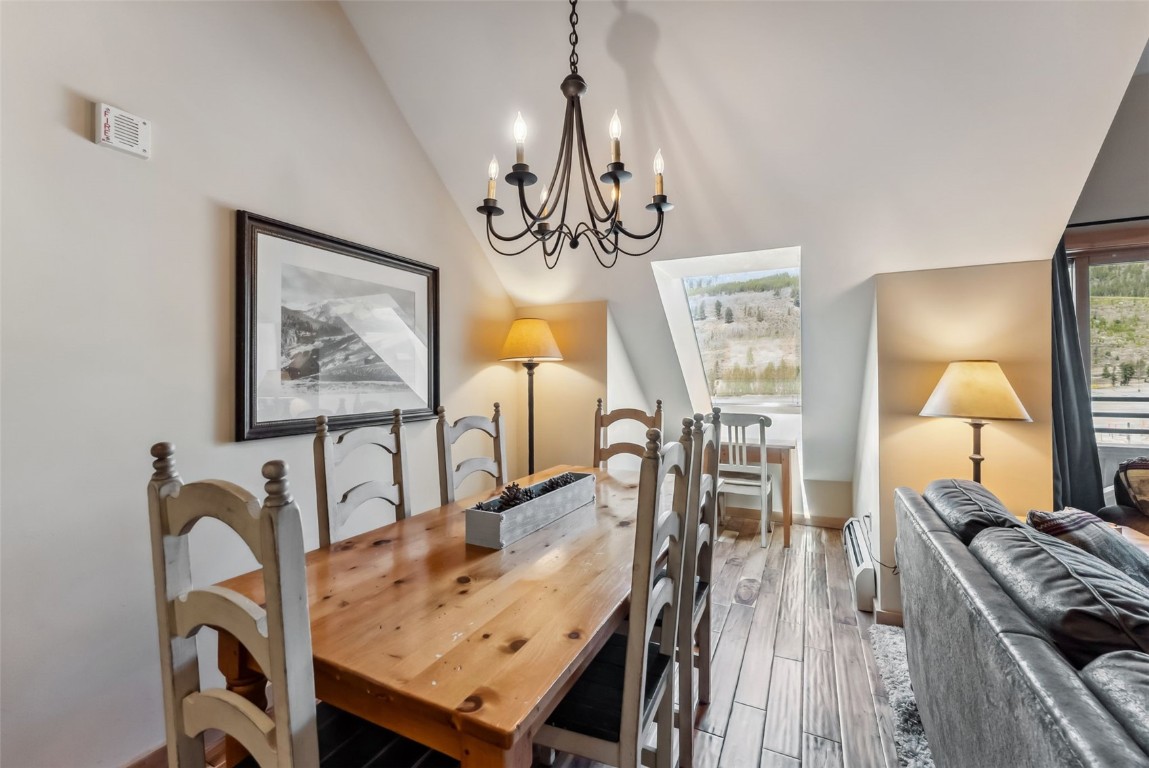 150 Dercum Square, Unit 8530 Keystone, CO 80435 - Photo 11 of 35 a view of a dining room with furniture a chandelier and wooden floor