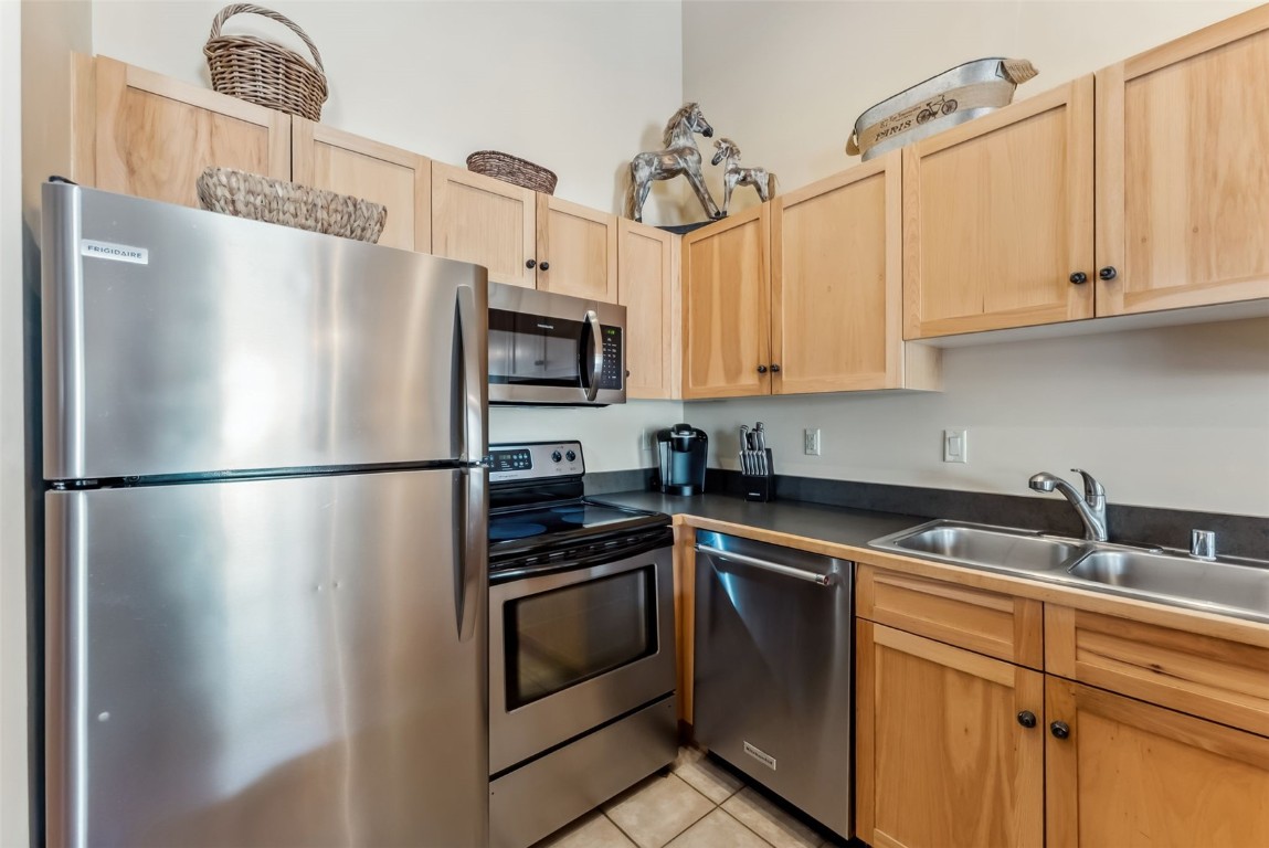 150 Dercum Square, Unit 8530 Keystone, CO 80435 - Photo 10 of 35 a kitchen with stainless steel appliances granite countertop a refrigerator sink and cabinets